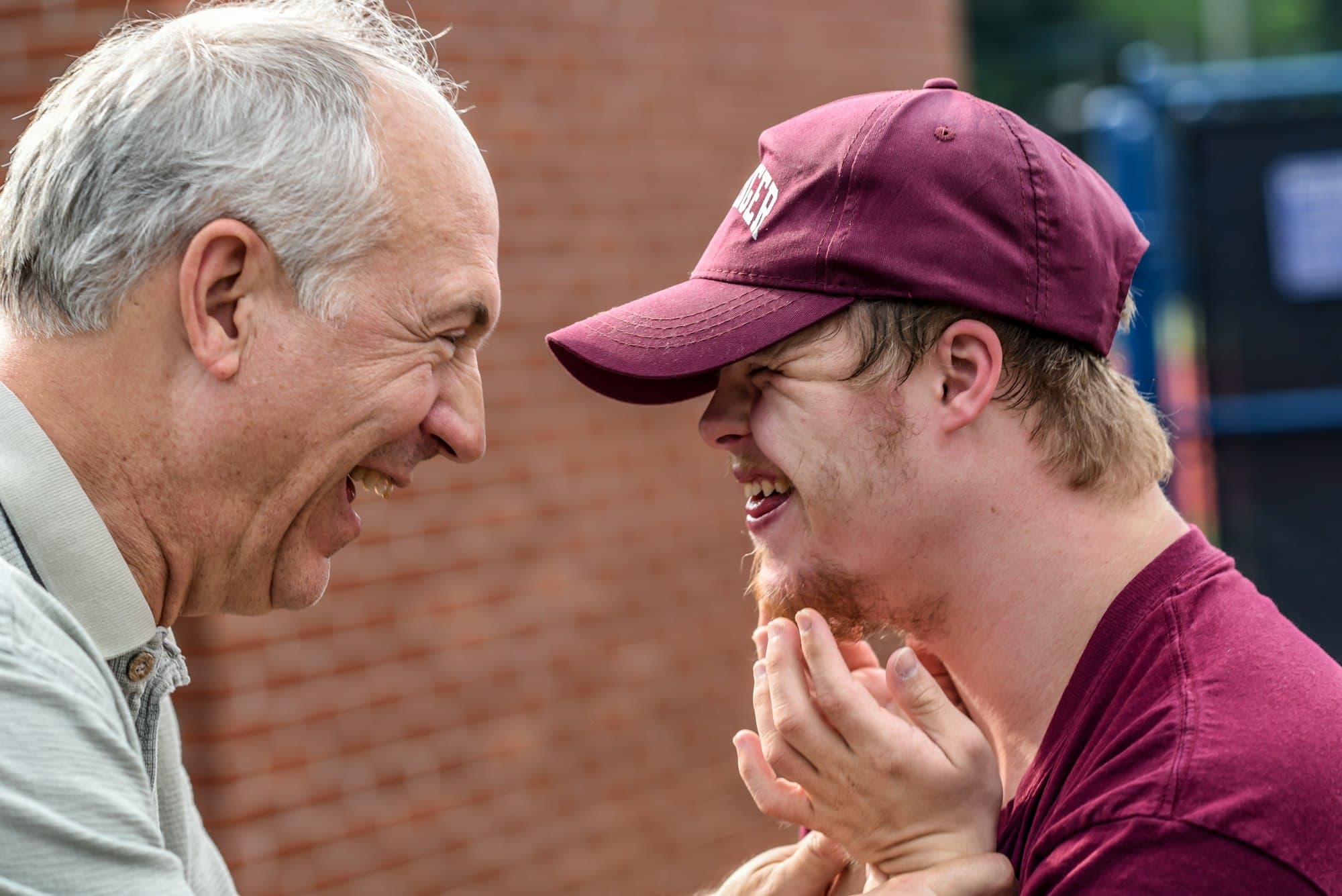 Two people laughing together, a warm and genuine moment of connection